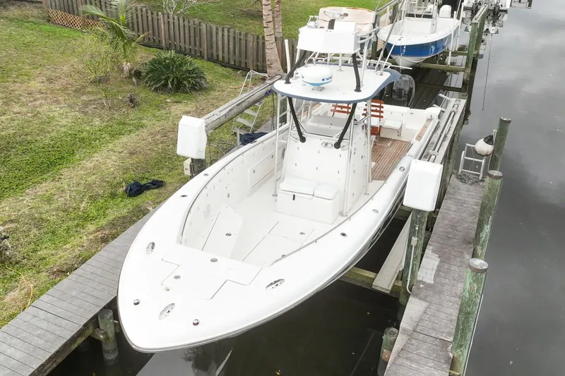 The Image of 2007 Triton 351 CC boat docked, aerial view, showcasing spacious deck and sleek design. - 0