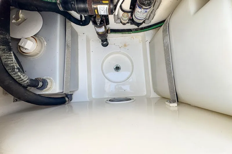 Slide: The Image of 2007 Triton 351 CC boat interior showing plumbing and storage compartments. - 100