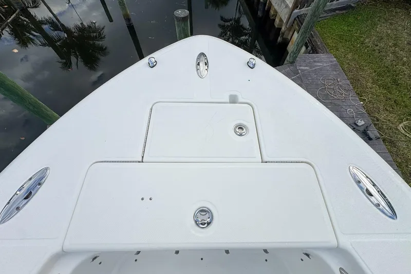 Slide: The Image of Bow of 2007 Triton 351 CC boat docked near water. - 103