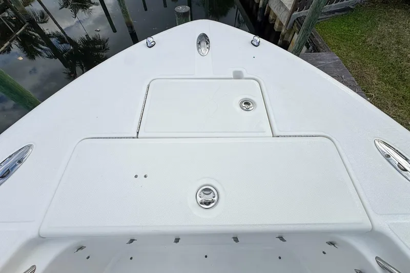 Slide: The Image of Bow of 2007 Triton 351 CC boat with storage compartments and cleats. - 104