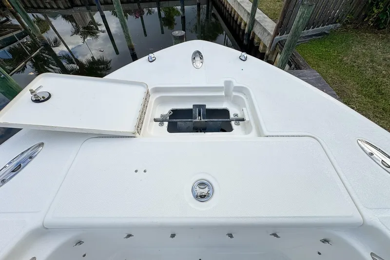 Slide: The Image of Bow of 2007 Triton 351 CC boat with open hatch and anchor storage. - 110