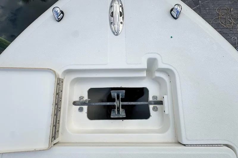 Slide: The Image of Anchor compartment of a 2007 Triton 351 CC boat, featuring a neatly stored anchor. - 111