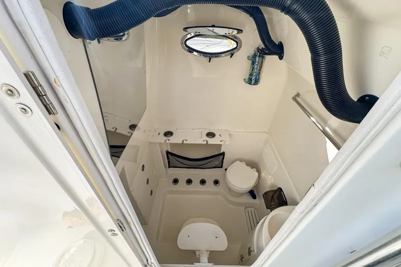 Slide: The Image of Interior of 2007 Triton 351 CC boat, featuring compact marine bathroom facilities. - 114