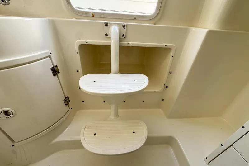 Slide: The Image of 2007 Triton 351 CC boat interior with steps and storage compartment. - 116