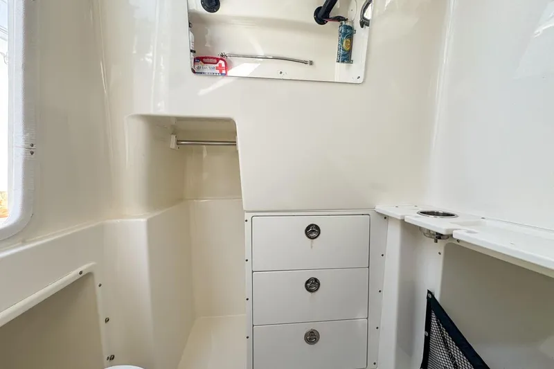 Slide: The Image of Interior of 2007 Triton 351 CC boat with storage drawers and shelves. - 119