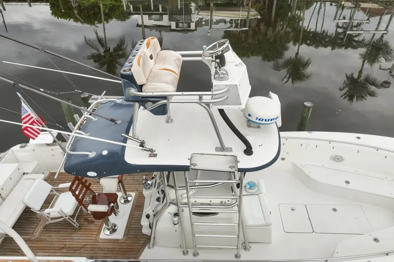 Slide: The Image of 2007 Triton 351 CC boat with elevated helm, fishing gear, and American flag. - 127