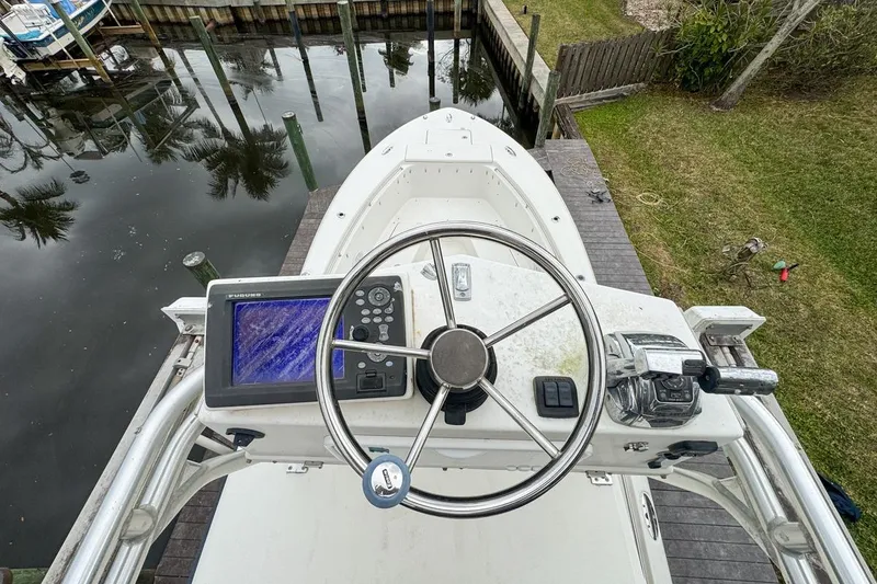 Slide: The Image of Top view of 2007 Triton 351 CC boat helm with steering wheel and navigation system. - 129