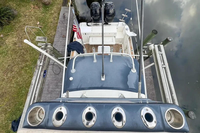 Slide: The Image of Overhead view of a 2007 Triton 351 CC boat docked by a wooden pier. - 133