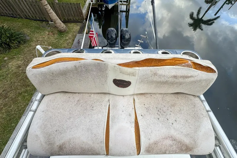 Slide: The Image of Worn seating on a 2007 Triton 351 CC boat, showing visible damage and wear. - 135