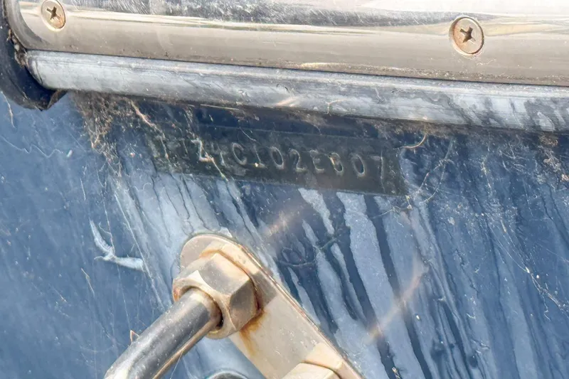 Slide: The Image of Close-up of a 2007 Triton 351 CC boat hull identification number. - 137