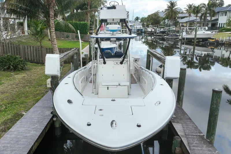 Slide: The Image of 2007 Triton 351 CC boat docked in a scenic canal setting. - 17