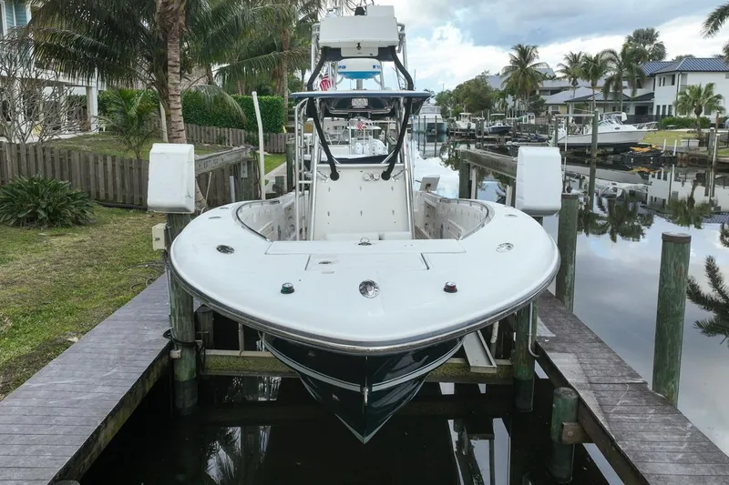 Slide: The Image of 2007 Triton 351 CC boat docked in a scenic canal with palm trees. - 18