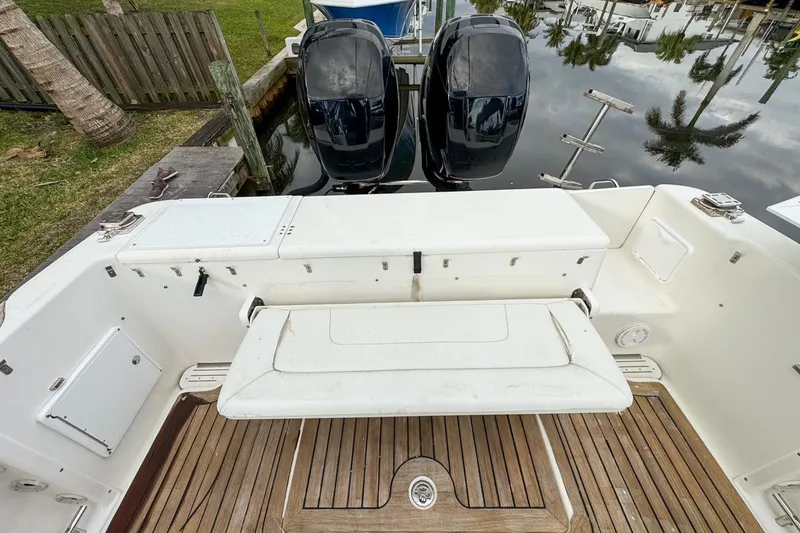 Slide: The Image of 2007 Triton 351 CC boat with dual outboard motors and wooden deck. - 30