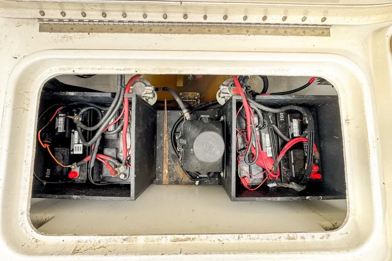 Slide: The Image of 2007 Triton 351 CC boat battery compartment with wiring and connections. - 34