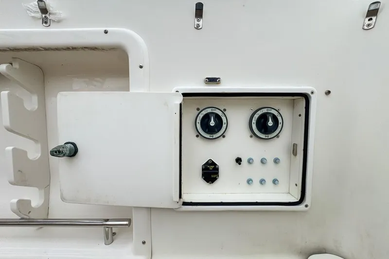 Slide: The Image of Control panel on a 2007 Triton 351 CC boat, featuring dials and switches. - 36