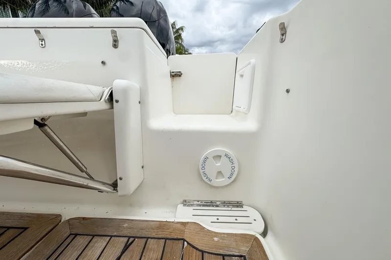 Slide: The Image of 2007 Triton 351 CC boat interior with washdown feature and wooden deck. - 37