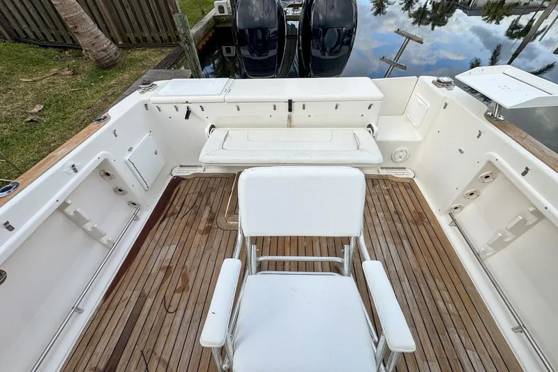 Slide: The Image of 2007 Triton 351 CC boat deck with seating and wooden flooring. - 39