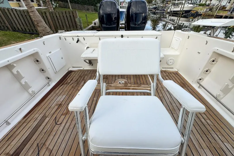 Slide: The Image of 2007 Triton 351 CC boat with white seating and wooden deck, featuring dual outboard motors. - 40
