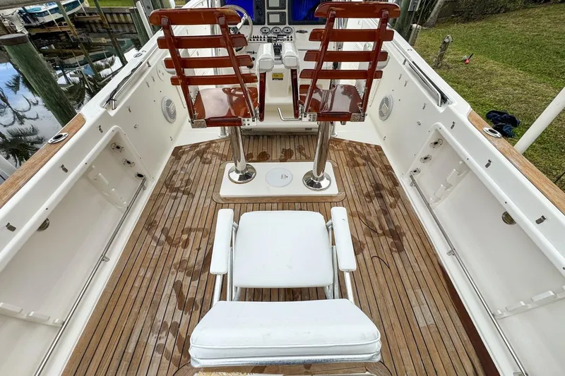 Slide: The Image of 2007 Triton 351 CC boat interior with wooden deck and seating arrangement. - 42