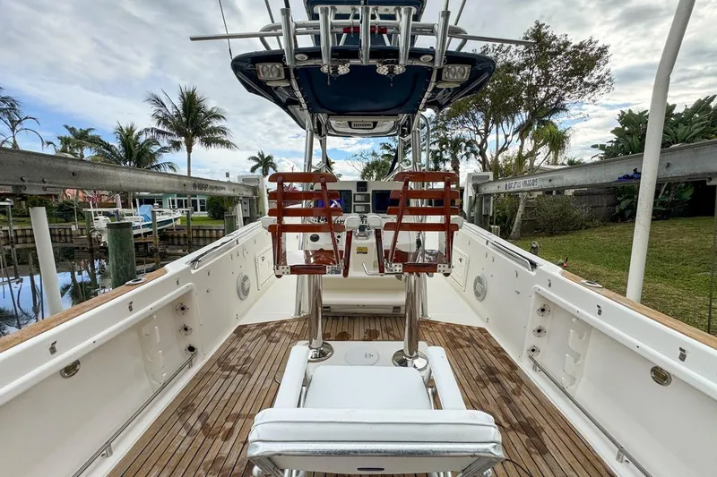 Slide: The Image of 2007 Triton 351 CC boat interior with wooden deck and fishing chair. - 44