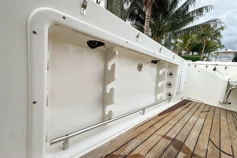 Slide: The Image of 2007 Triton 351 CC boat interior with rod holders and wooden deck. - 46