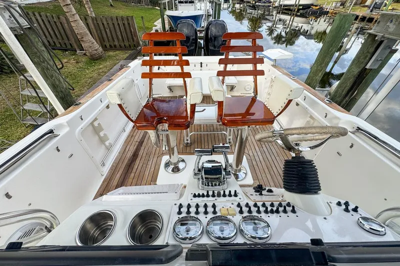 Slide: The Image of 2007 Triton 351 CC boat cockpit with wooden chairs and control panel. - 50
