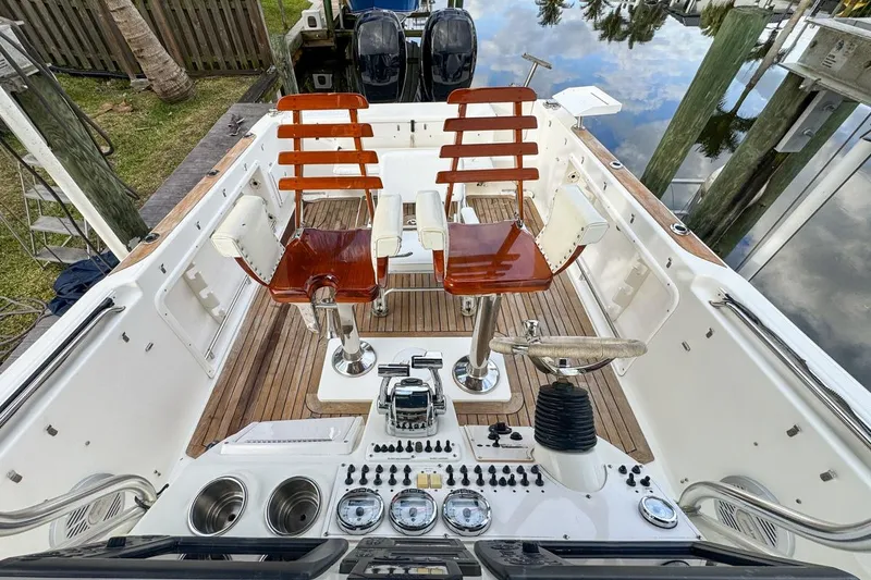 Slide: The Image of 2007 Triton 351 CC boat interior with wooden seats and control panel. - 51