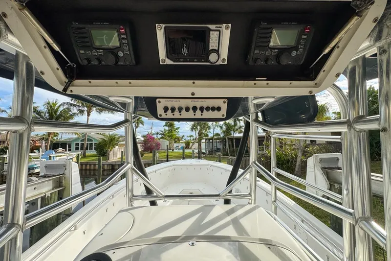 Slide: The Image of 2007 Triton 351 CC boat interior with control panel and scenic waterfront view. - 55