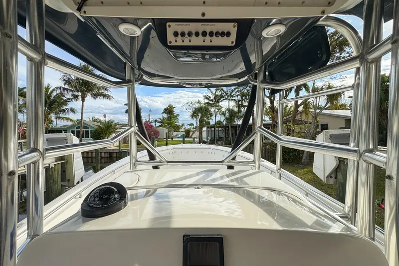 Slide: The Image of 2007 Triton 351 CC boat interior with chrome railings and tropical background. - 56