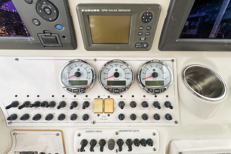 Slide: The Image of Control panel of a 2007 Triton 351 CC boat with gauges and switches. - 58