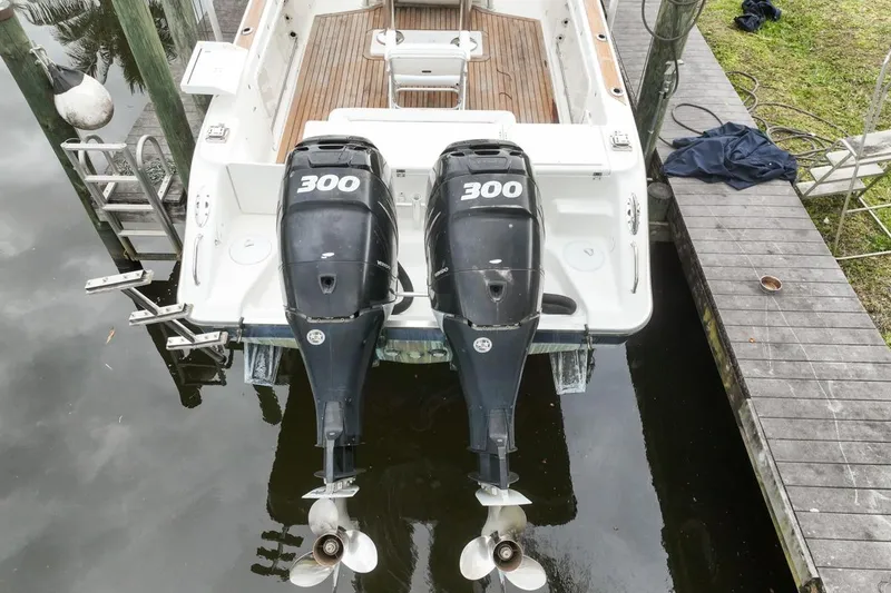 Slide: The Image of 2007 Triton 351 CC boat with twin 300 horsepower outboard engines docked. - 6