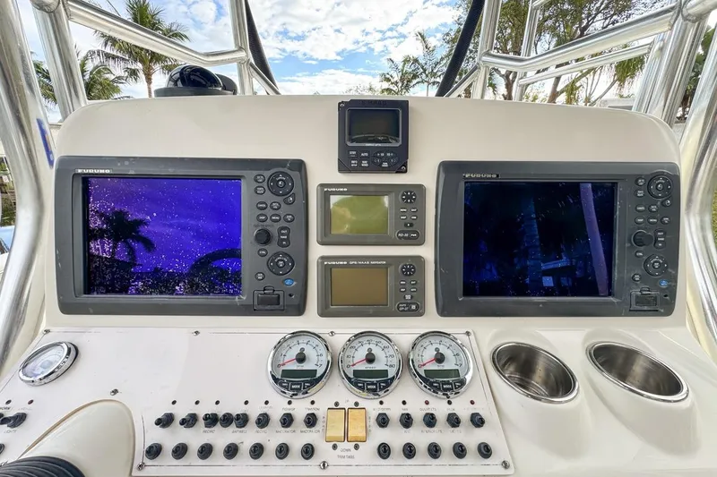 Slide: The Image of Control panel of a 2007 Triton 351 CC boat with multiple navigation screens. - 61