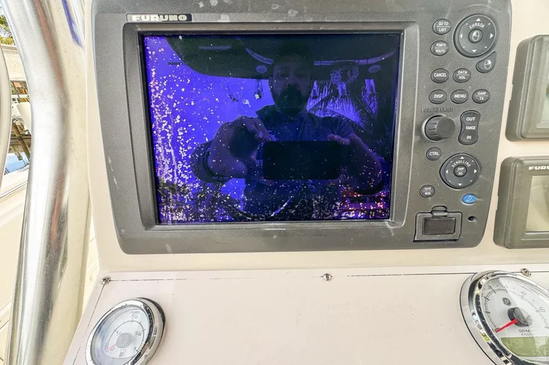 Slide: The Image of 2007 Triton 351 CC boat dashboard with Furuno display and gauges. - 63