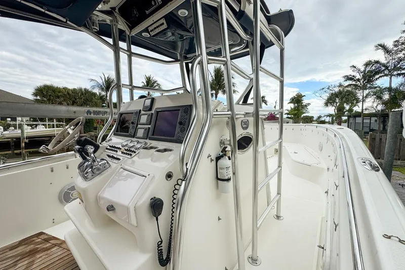 Slide: The Image of 2007 Triton 351 CC boat cockpit with navigation equipment and steering wheel. - 68