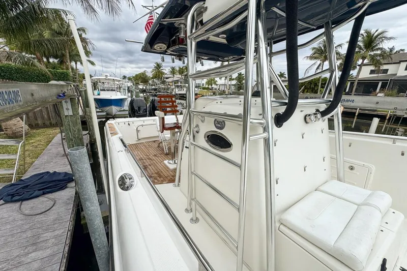 Slide: The Image of 2007 Triton 351 CC boat docked, featuring sleek design and spacious deck. - 69