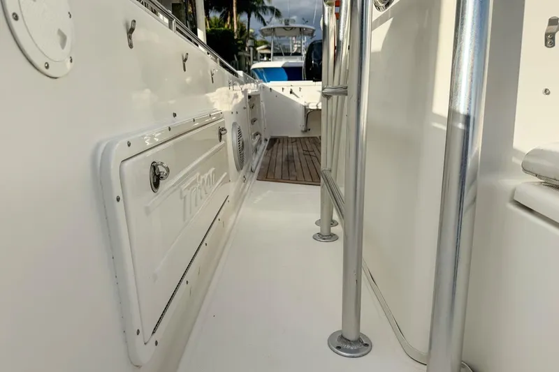 Slide: The Image of 2007 Triton 351 CC boat deck with stainless steel railings and storage compartment. - 70