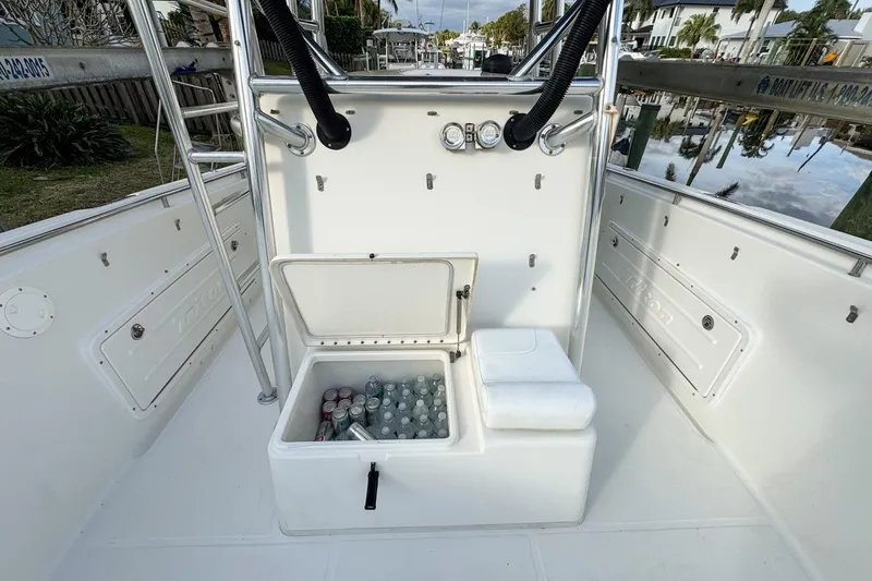 Slide: The Image of 2007 Triton 351 CC boat interior with open cooler filled with drinks. - 79