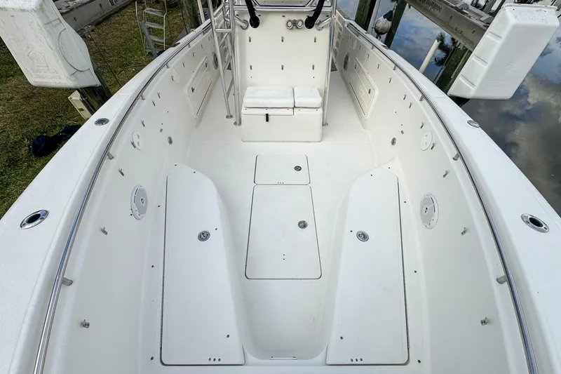 Slide: The Image of 2007 Triton 351 CC boat interior, featuring spacious white deck and seating area. - 81