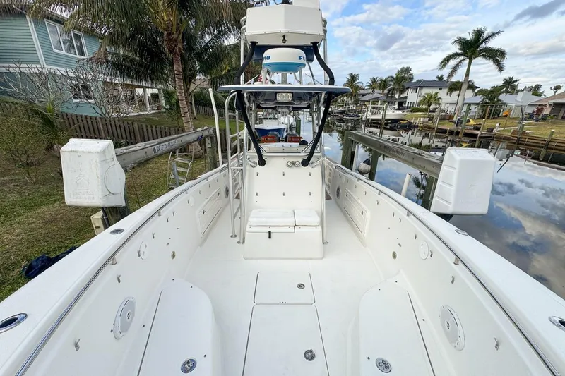 Slide: The Image of 2007 Triton 351 CC boat docked in a scenic canal with palm trees. - 84