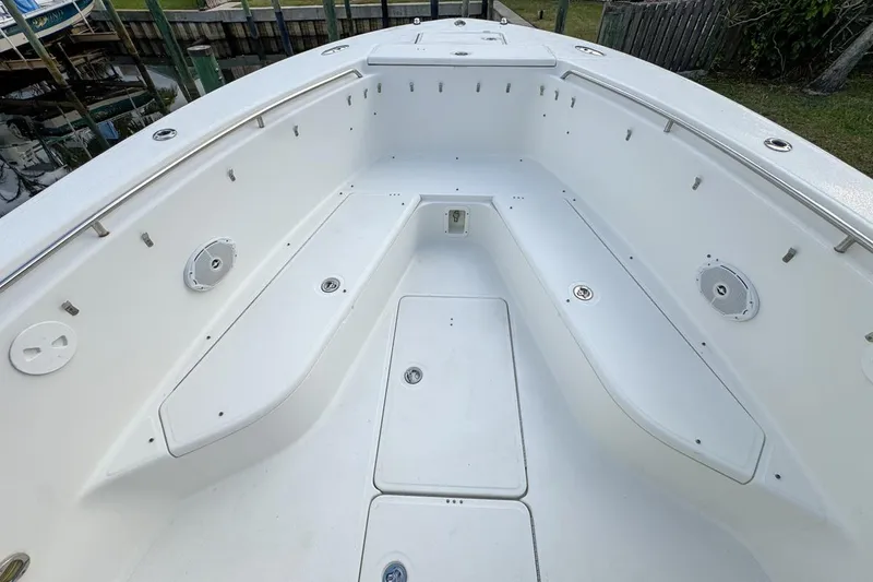 Slide: The Image of 2007 Triton 351 CC boat interior, featuring spacious seating and clean white design. - 86