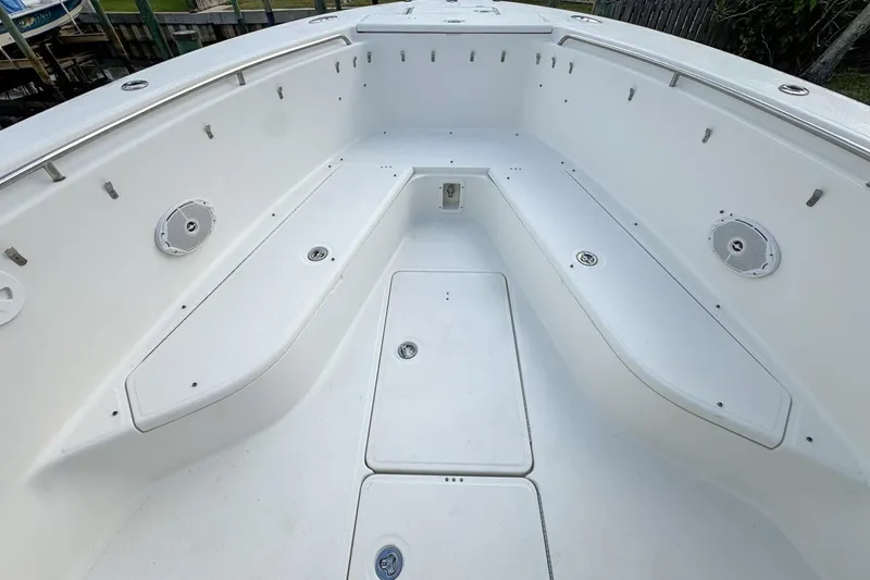 Slide: The Image of 2007 Triton 351 CC boat interior with spacious seating and storage compartments. - 87