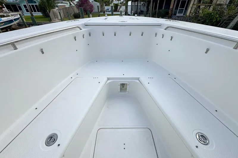 Slide: The Image of 2007 Triton 351 CC boat interior with spacious seating and storage compartments. - 88