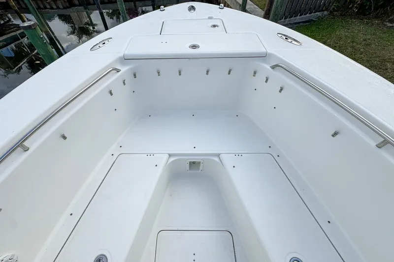 Slide: The Image of 2007 Triton 351 CC boat interior, featuring spacious white deck and stainless steel railings. - 90