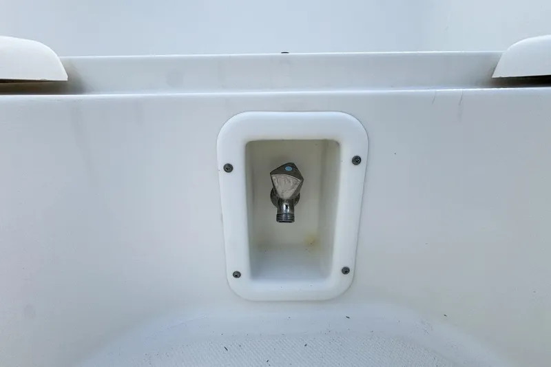 Slide: The Image of Water outlet on 2007 Triton 351 CC boat, recessed in white panel. - 91