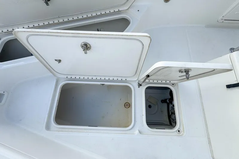 Slide: The Image of Open storage compartments on a 2007 Triton 351 CC boat deck. - 97