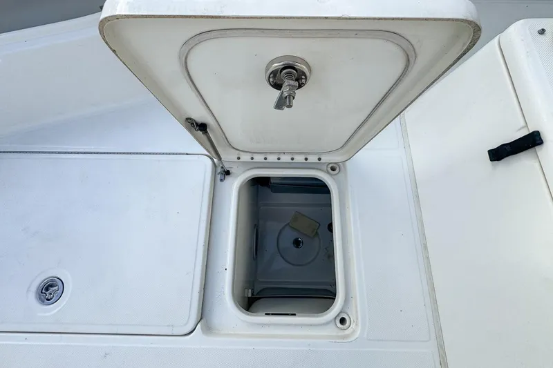 Slide: The Image of Open storage compartment on a 2007 Triton 351 CC boat deck. - 99