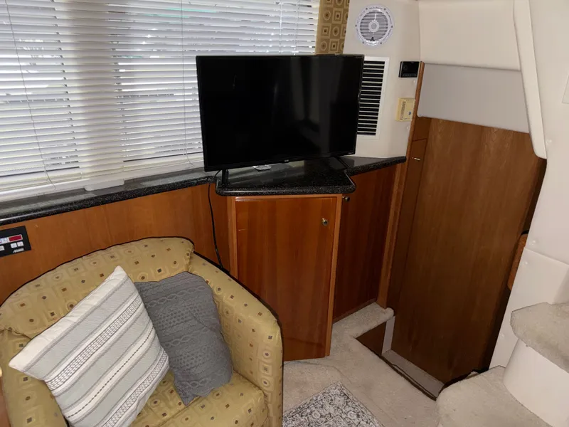 Slide: The Image of Interior of Carver 356 Aft Cabin Yacht, cozy seating area with TV. - 31