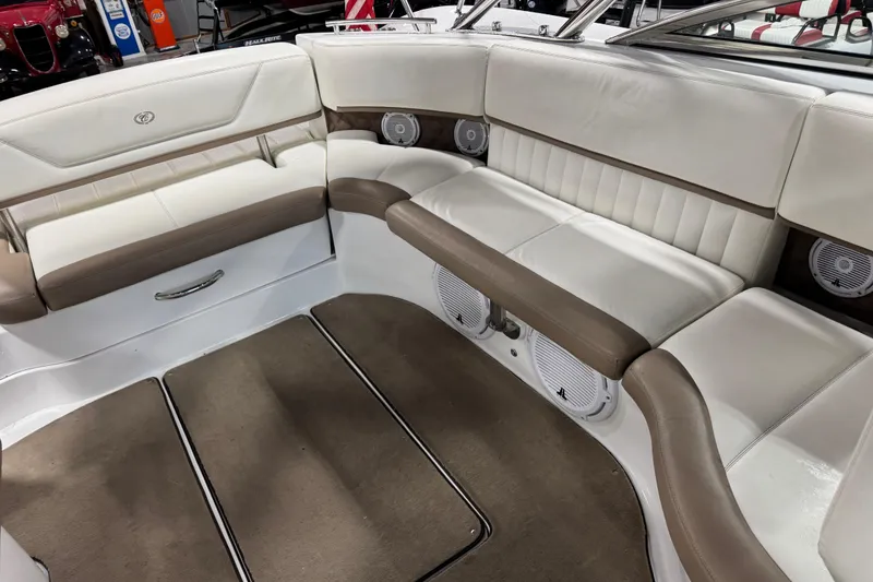 Slide: The Image of Interior of a 2011 Cobalt boat with white and brown seating. - 11