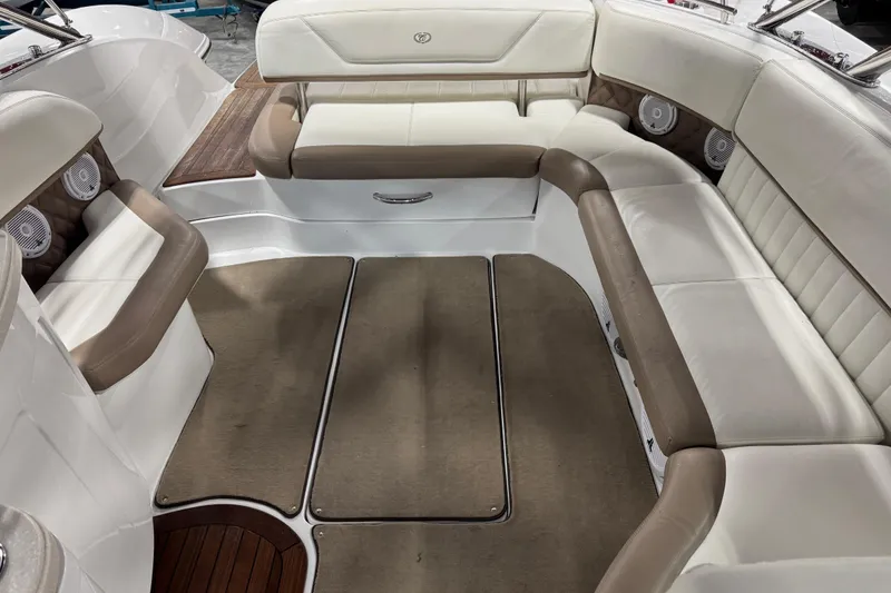 Slide: The Image of 2011 Cobalt boat interior with beige and white seating, featuring built-in speakers. - 14