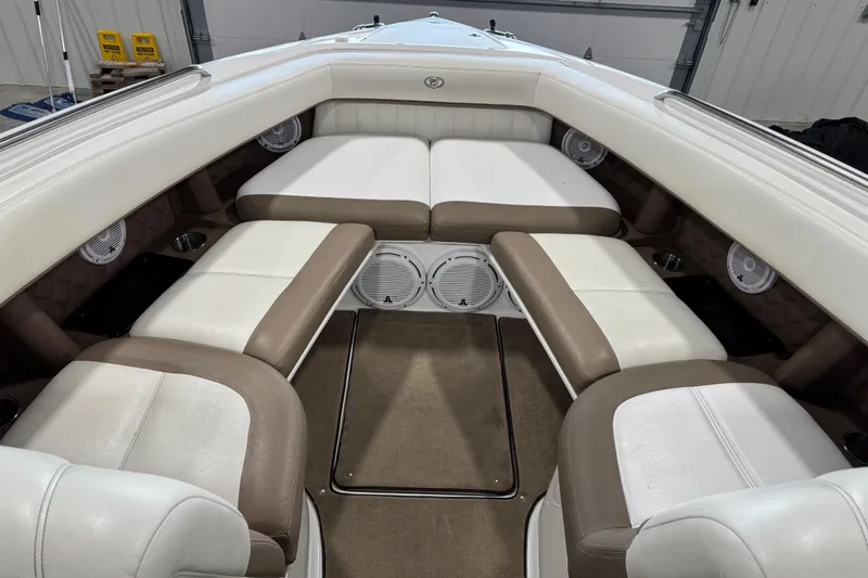 Slide: The Image of Luxurious 2011 Cobalt boat interior with white and brown seating, featuring built-in speakers. - 6
